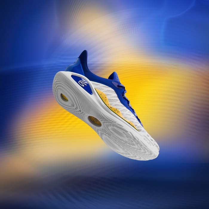 Side view of Stephen Curry's white, blue, and gold sneakers.